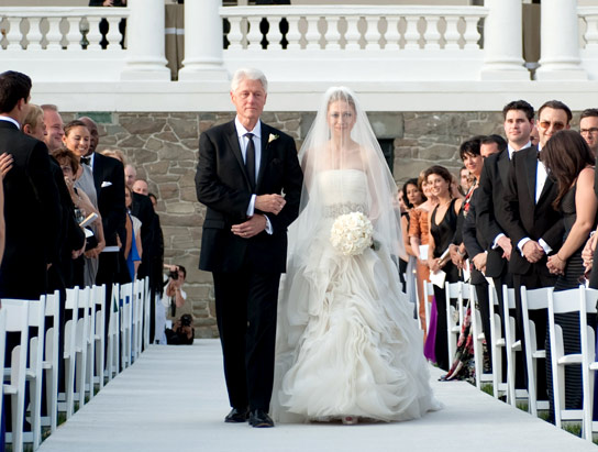 In this handout image provided by Genevieve de Manio, former U.S. President Bill Clinton (L) walks Chelsea Clinton down the aisle during her wedding to Marc Mezvinsky at the Astor Courts Estate on July 31, 2010 in Rhinebeck, New York.